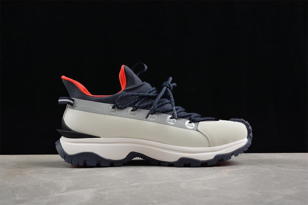 Side view of the sneaker highlighting its white midsole and navy laces.