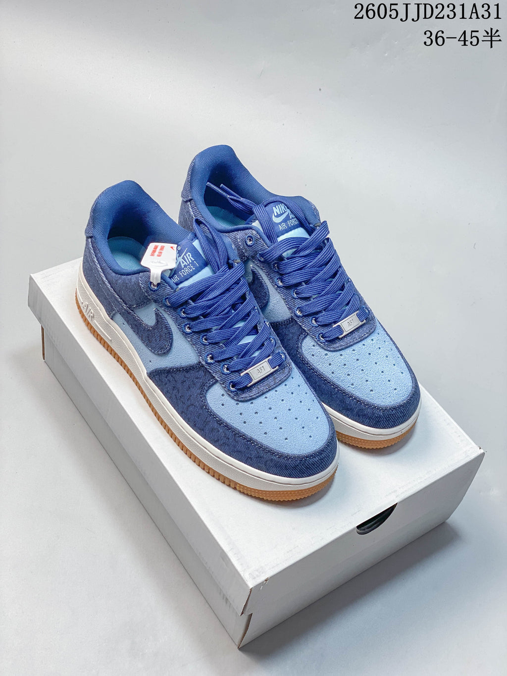 Pair of blue Nike Air Force 1 Low sneakers with light blue panels and gum-colored outsoles