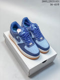 Pair of blue Nike Air Force 1 Low sneakers with light blue panels and gum-colored outsoles
