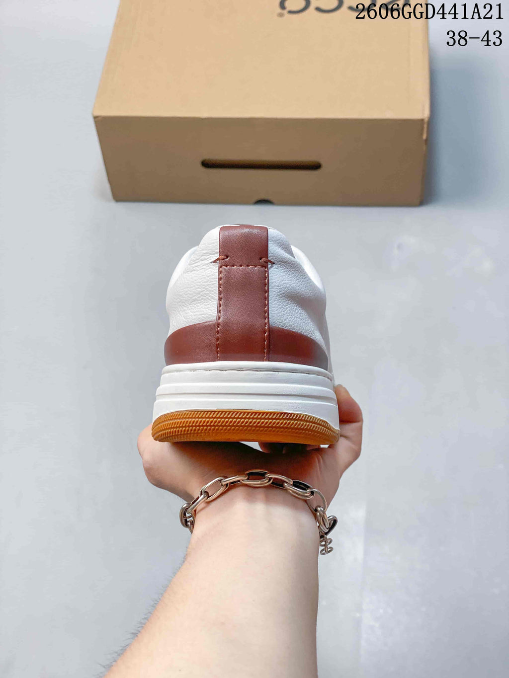 Rear view of the sneaker showing its brown heel accents and gum-colored outsole.