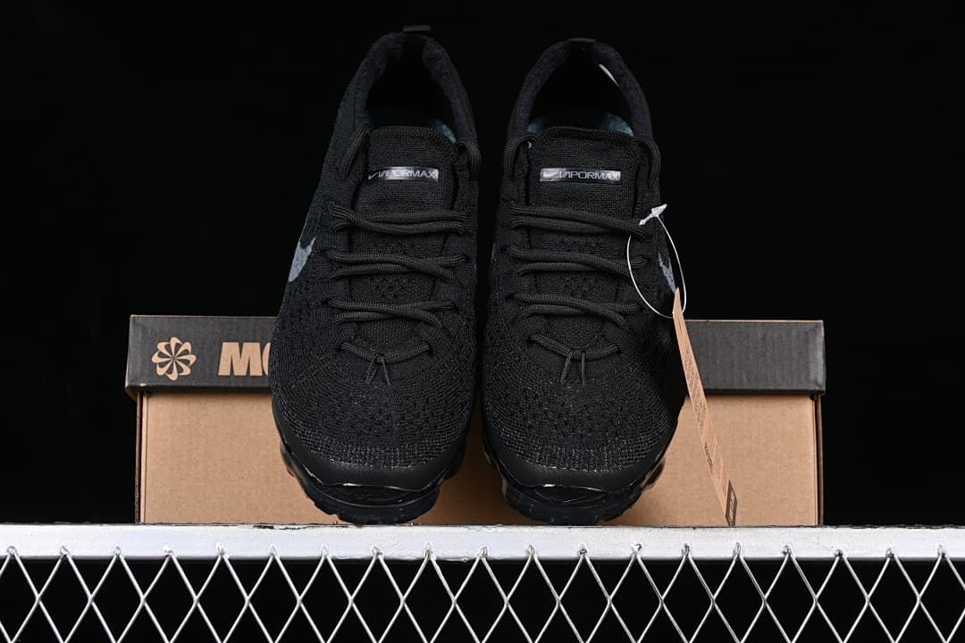 Front view of the pair of black sneakers with gray Swoosh details