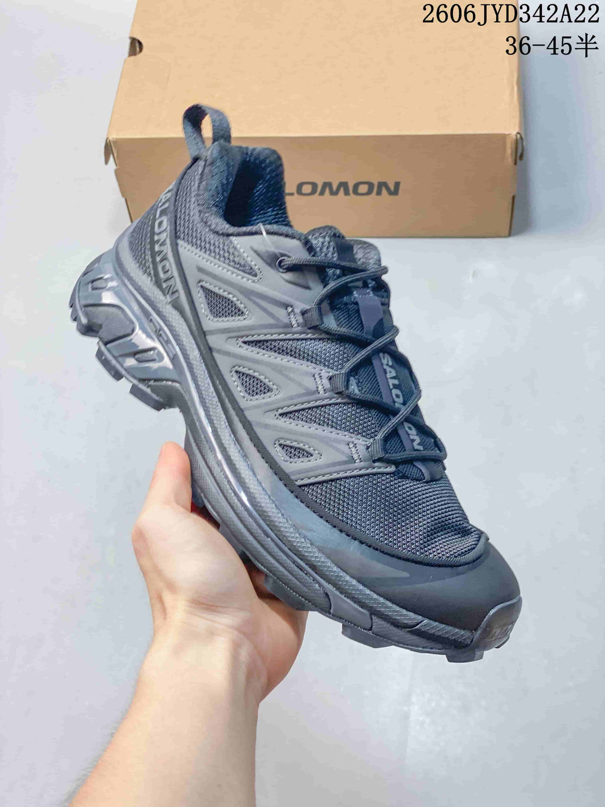 Angled side view of the charcoal-gray Salomon sneaker