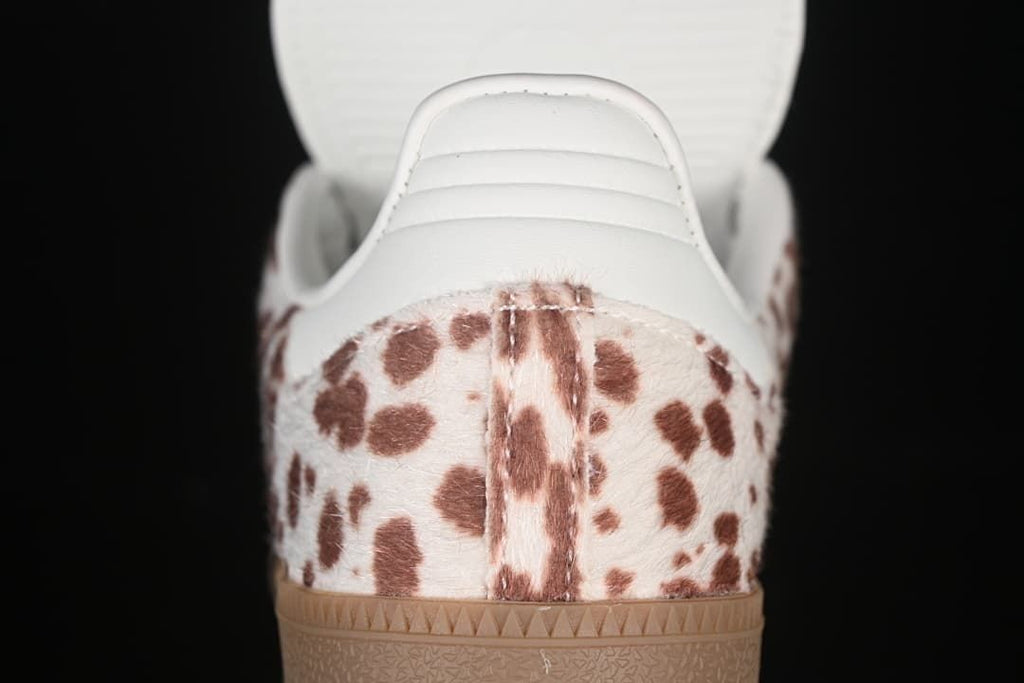 Rear view of spotted heel panel, white heel tab, and gum sole