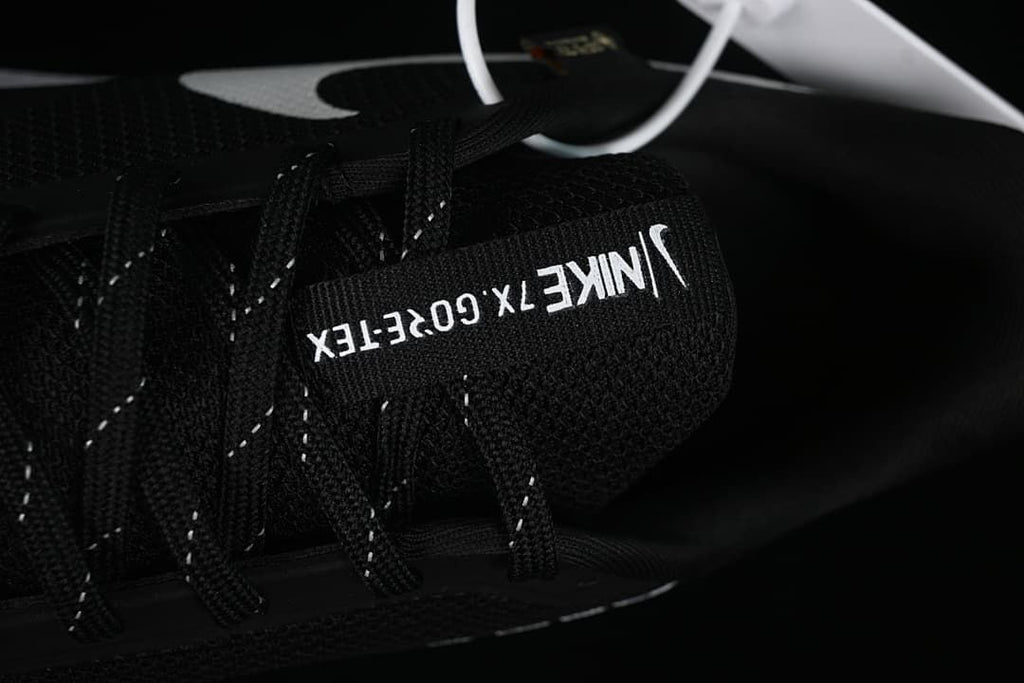 Close-up of tongue branding and black laces