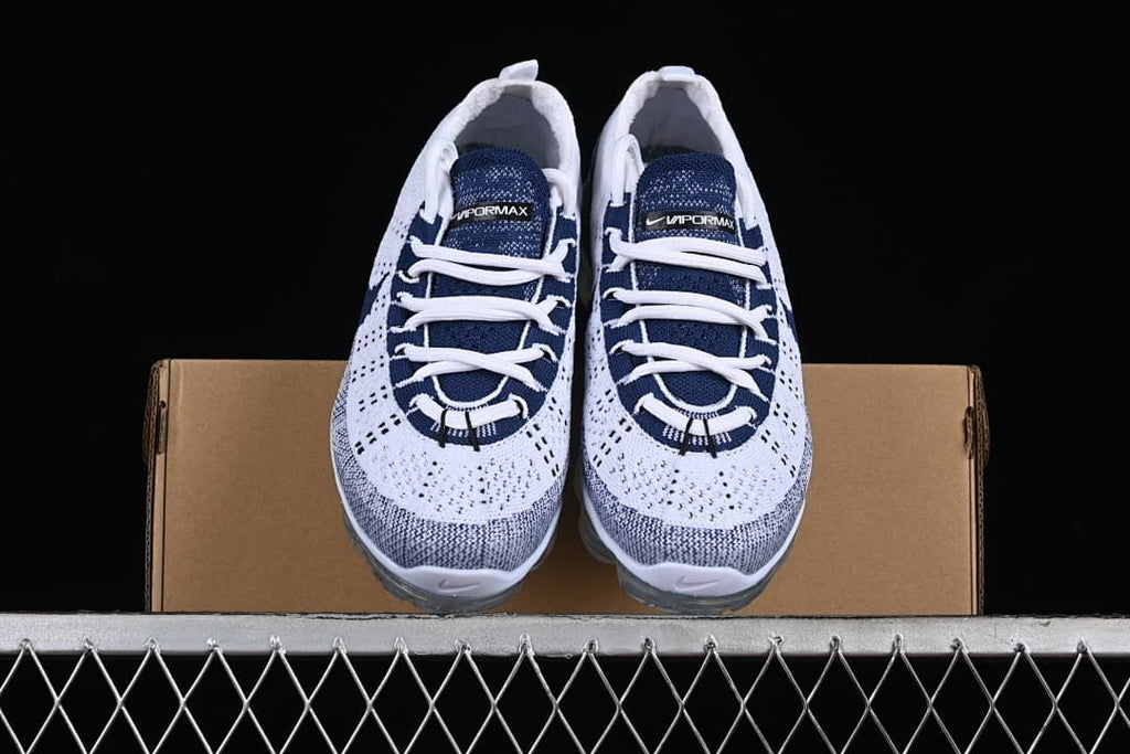 Front view of the pair of white and navy Nike Air VaporMax sneakers