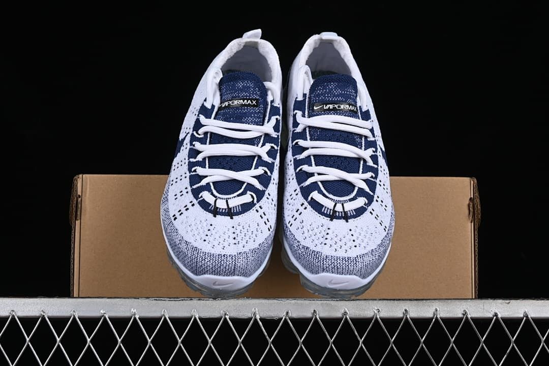 Front view of the pair of white and navy Nike Air VaporMax sneakers