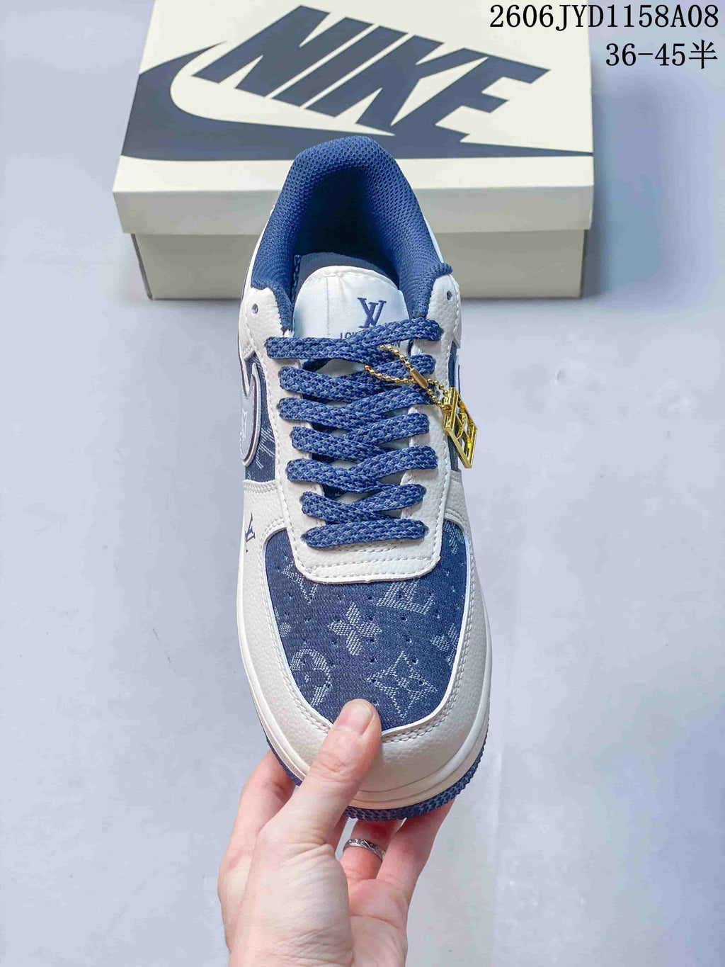 Top view of a blue and white patterned lace-up sneaker with blue laces