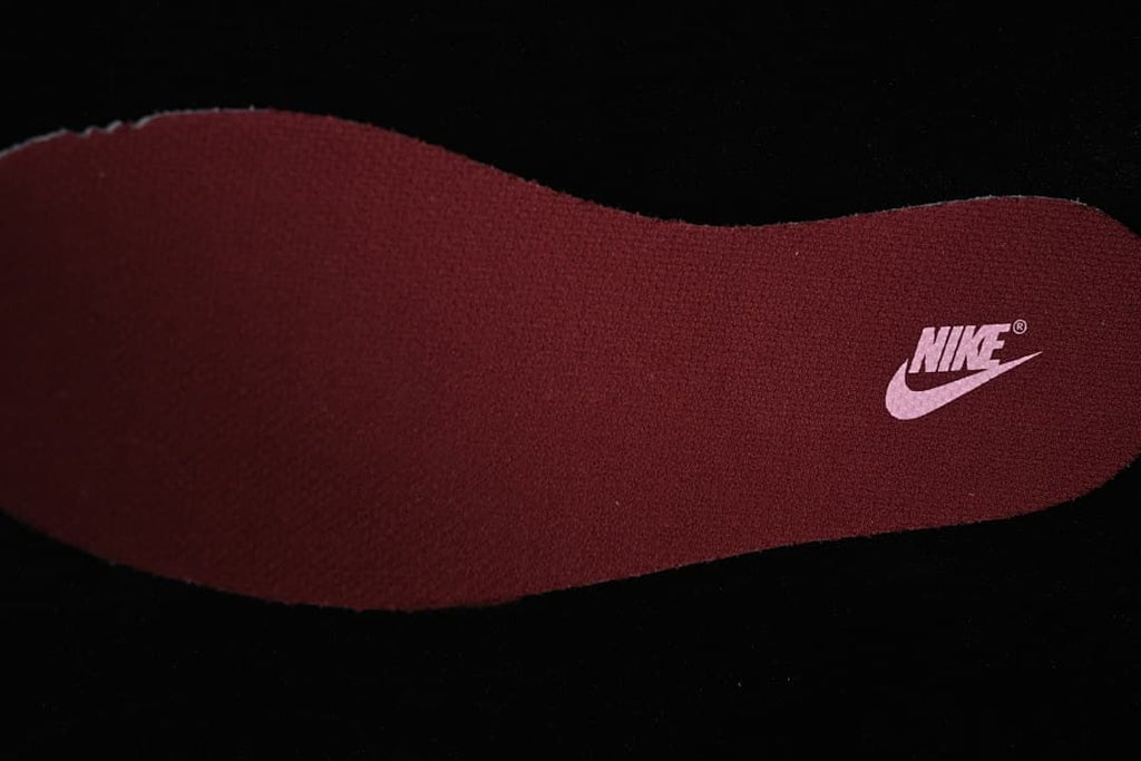 Close-up of a burgundy shoe insole with a Nike mark