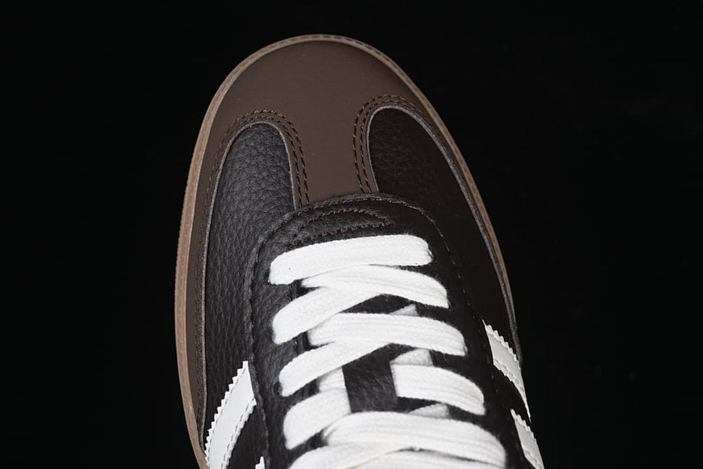 Top-down detail of the brown toe panels and white laces