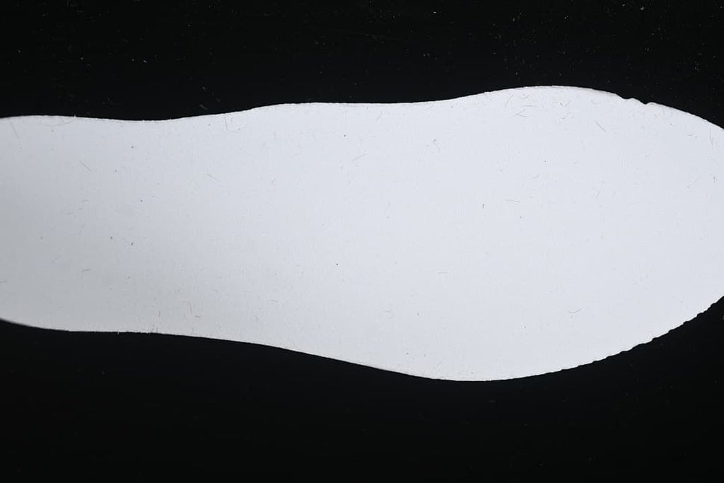 White shoe-shaped insert displayed on a dark background