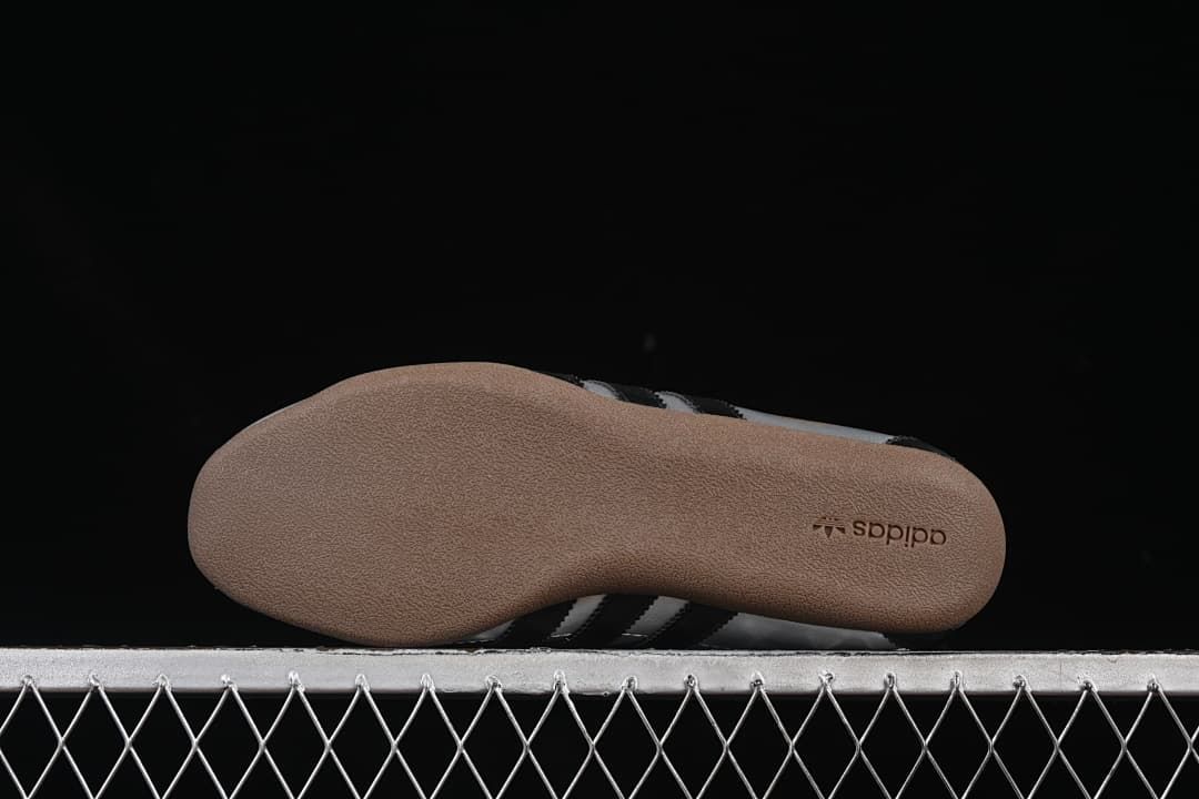 Underside of the gum-colored outsole with adidas branding
