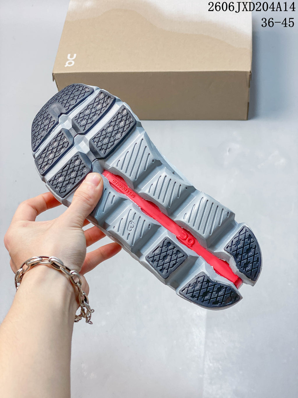 Underside view showing the segmented gray outsole and dark tread sections.
