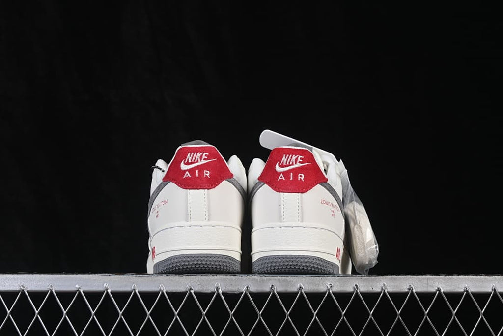 Rear view showing red heel tabs, white uppers, and gray outsoles