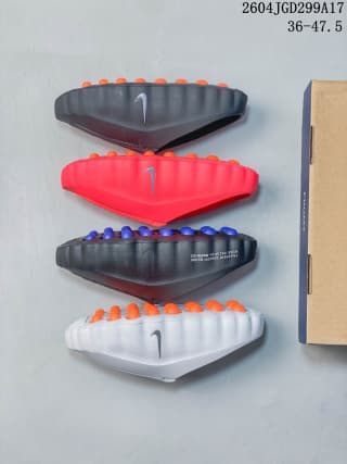 Bottom and side comparison of dark, red, black, and white Nike Mind slides showing different outsole and footbed node colors.