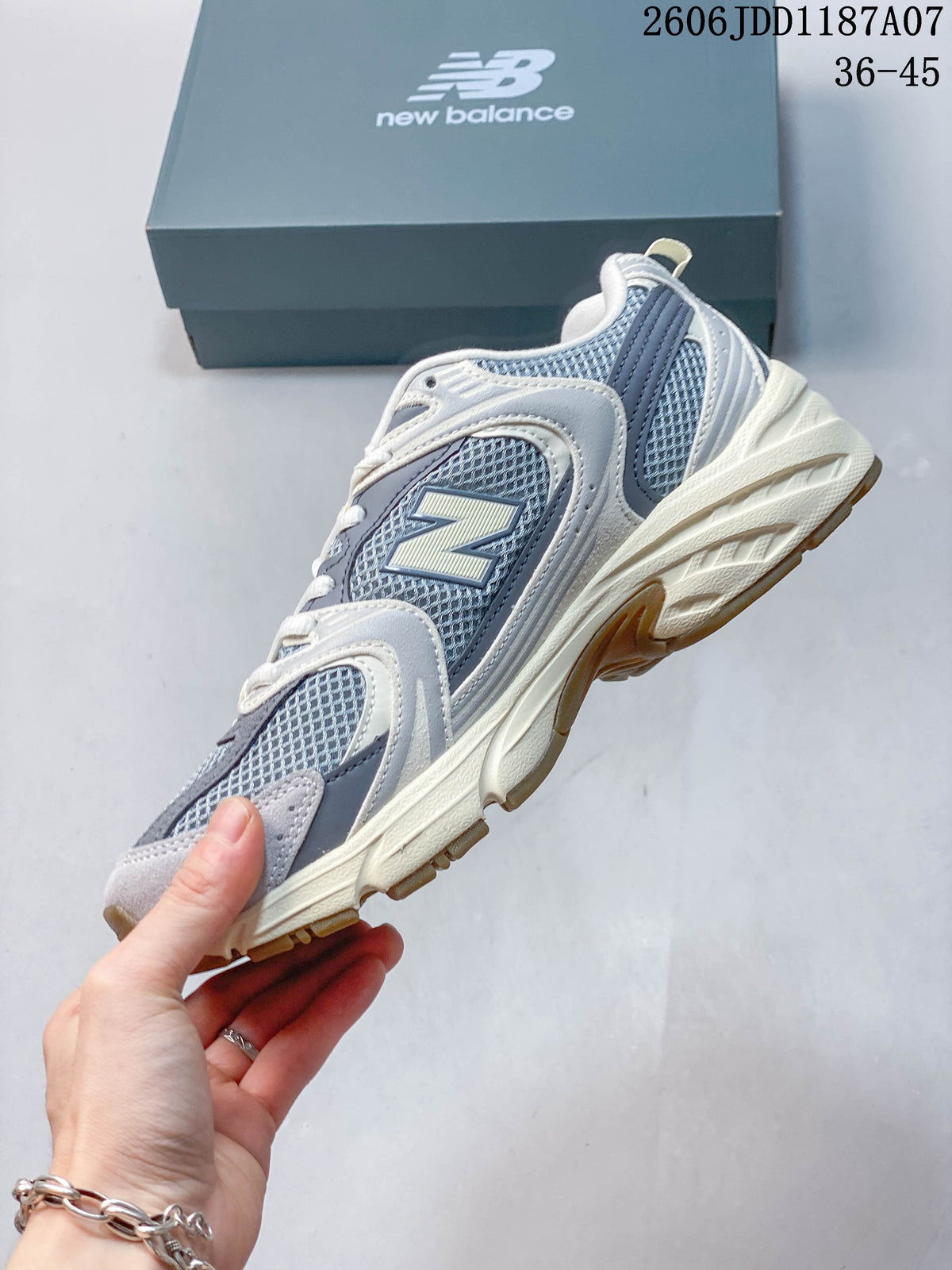 Side view of the grey mesh sneaker with layered overlays and an off-white sculpted sole.