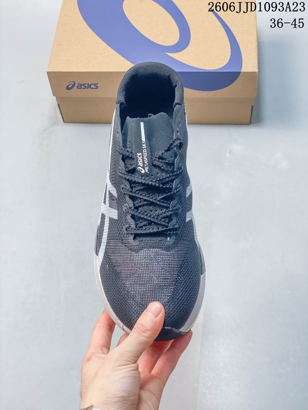 Front view of the gray lace-up running shoe with white side detailing.