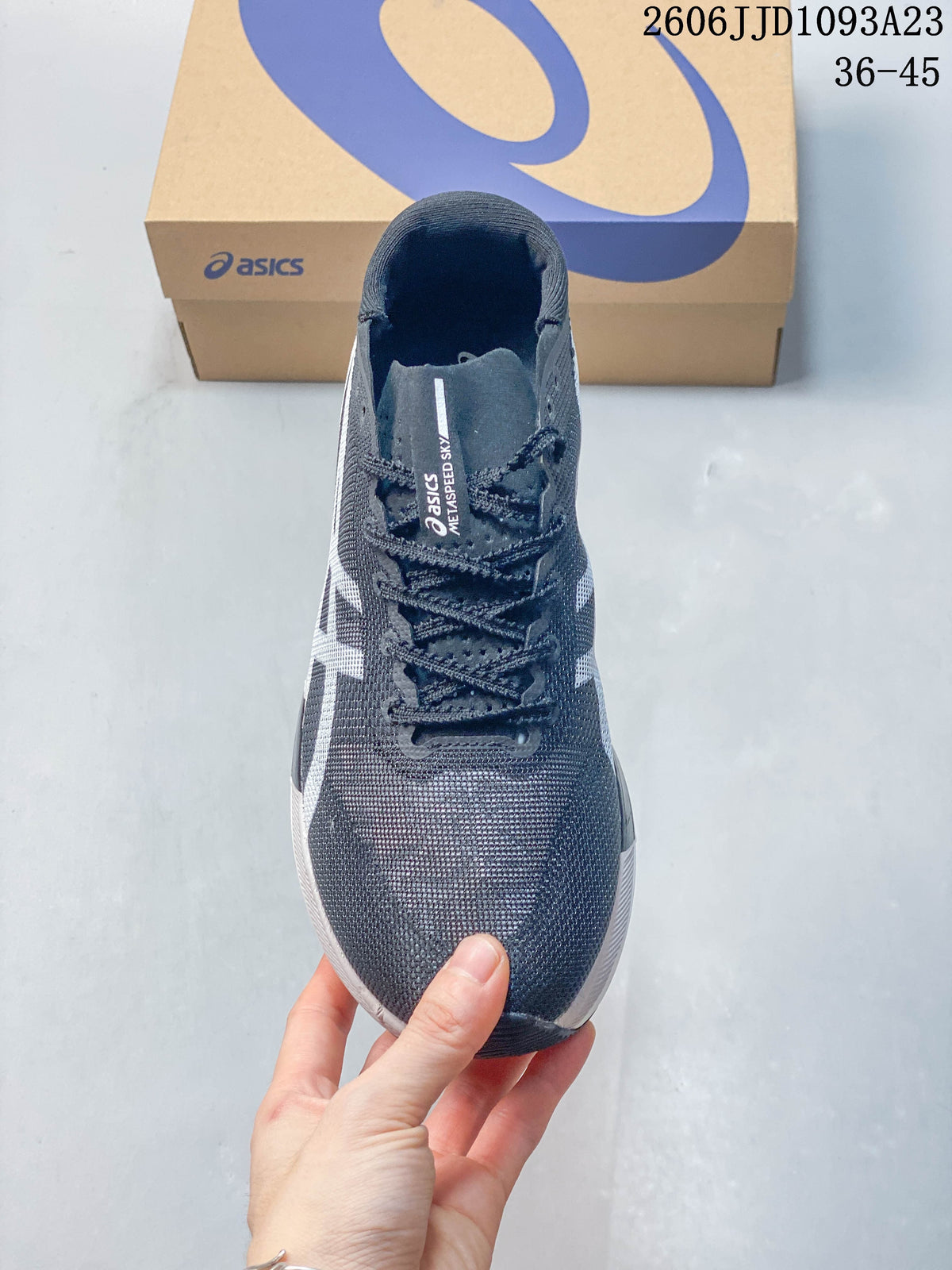 Front view of the gray lace-up running shoe with white side detailing.