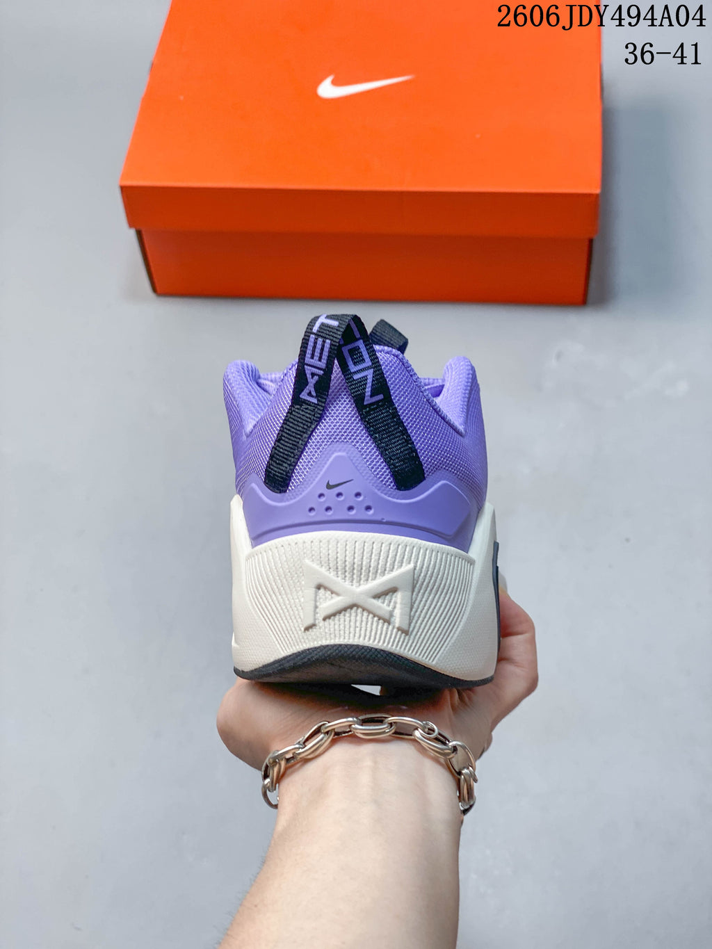 Rear view showing the heel and contrasting midsole of the purple training shoe.