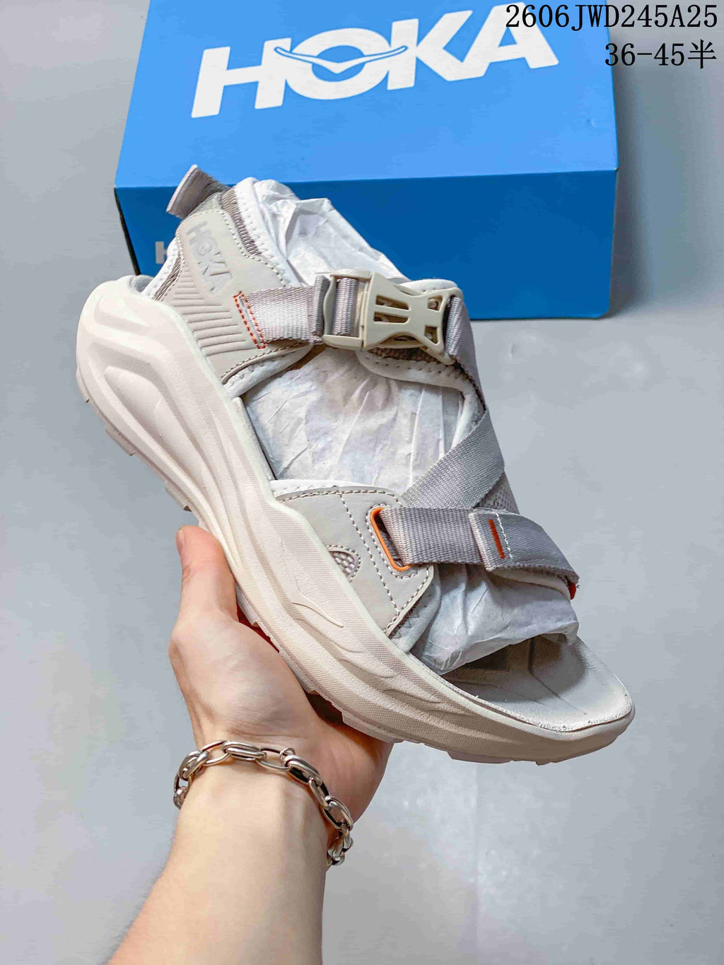 Light gray HOKA Infini Hike TC sandal with orange accents