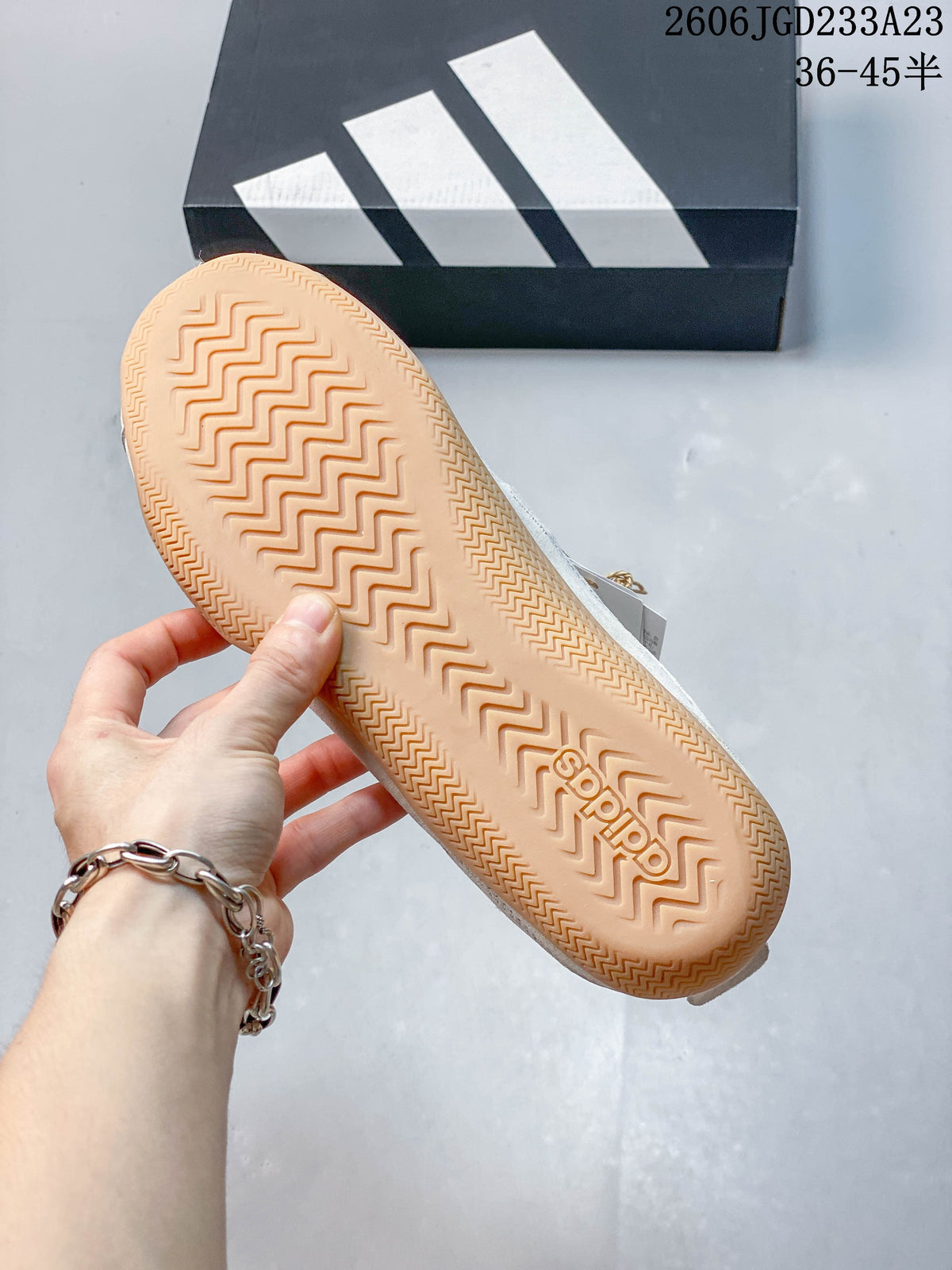 Close-up of the gum-colored outsole and patterned tread on an adidas Urban Reverie sneaker