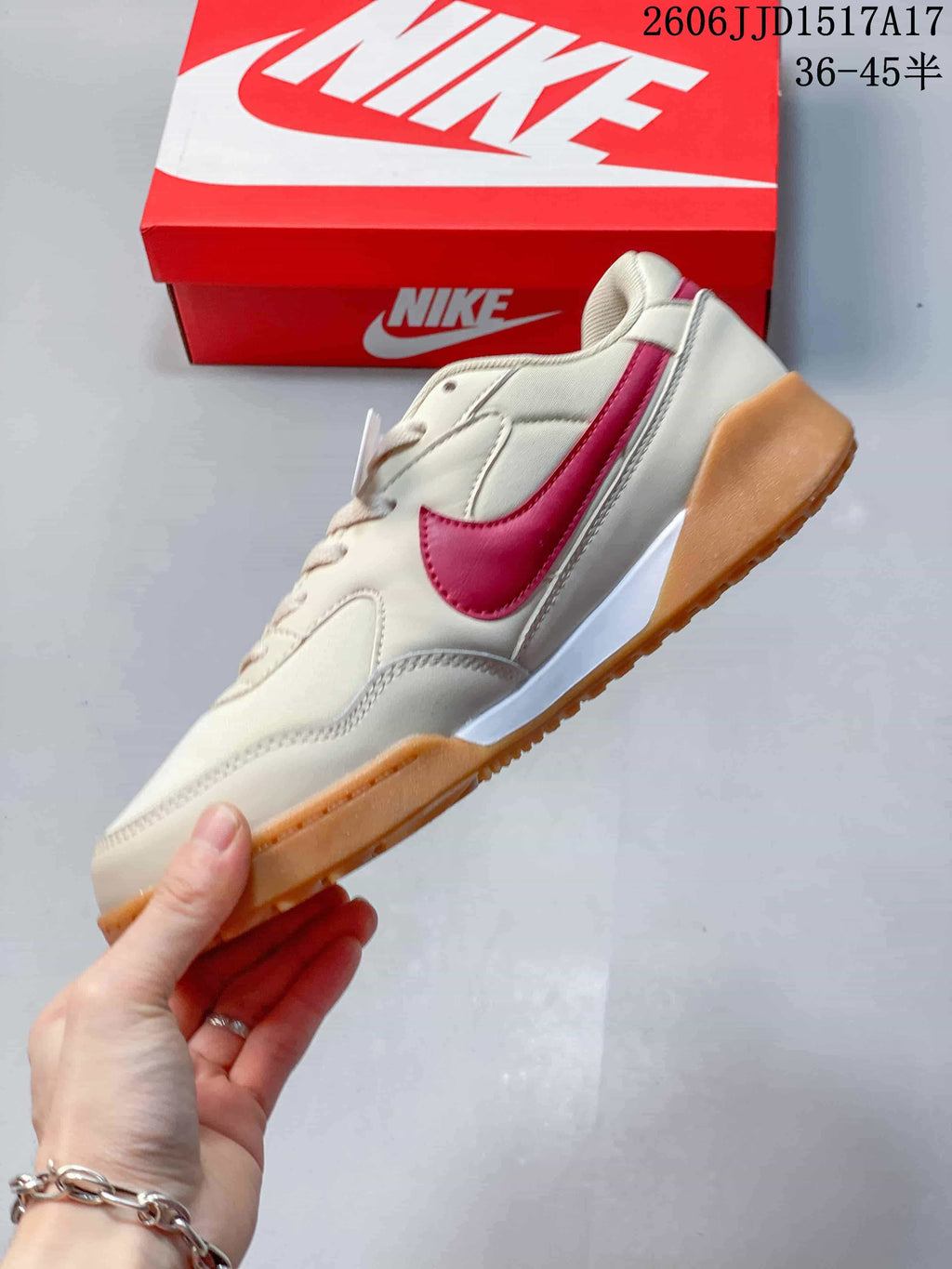 Side view of a cream Nike Terra Manta sneaker with pink Swoosh and gum-colored outsole