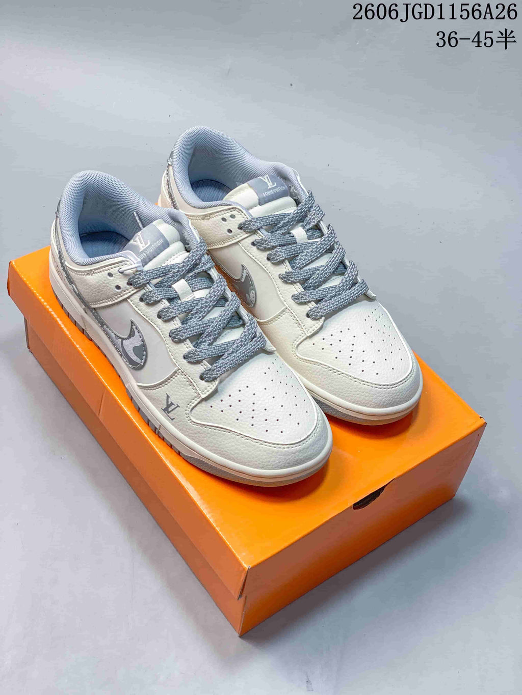Pair of white low-top sneakers with gray accents and perforated toe panels