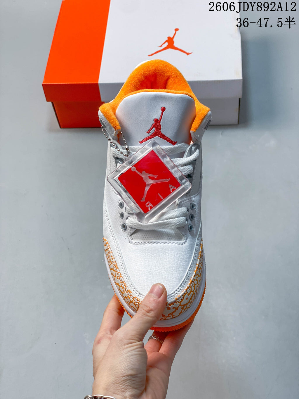 Top view of the lace-up front, orange lining, and branded tongue.