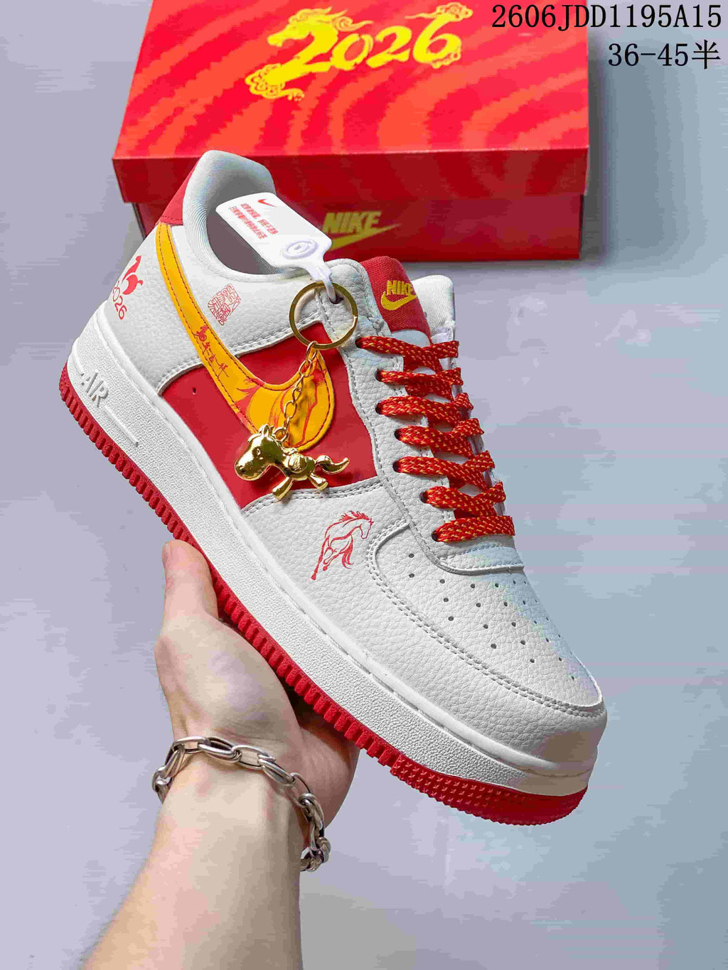 Angled side view showing horse graphics, a gold-tone charm, and red outsole