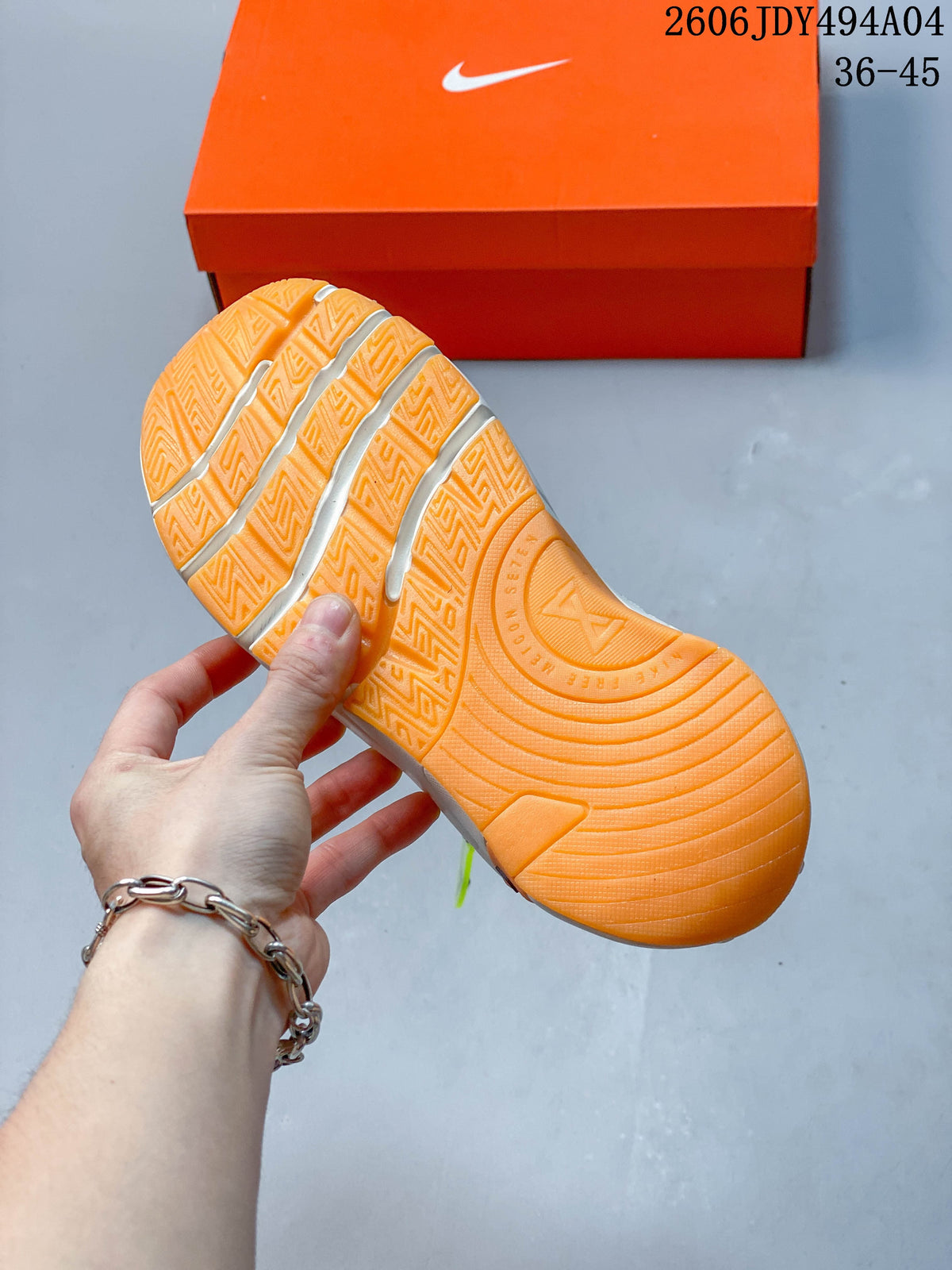 Close-up of the orange rubber outsole tread on the training shoe.