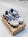 Pair of silver and gray Mizuno Prophecy 8 sneakers on a shoebox