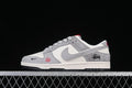 Side view of gray and off-white low-top sneakers with patterned laces and red accents