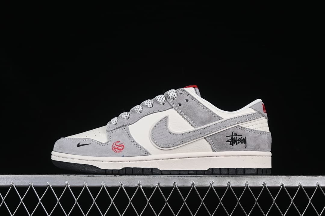 Side view of gray and off-white low-top sneakers with patterned laces and red accents