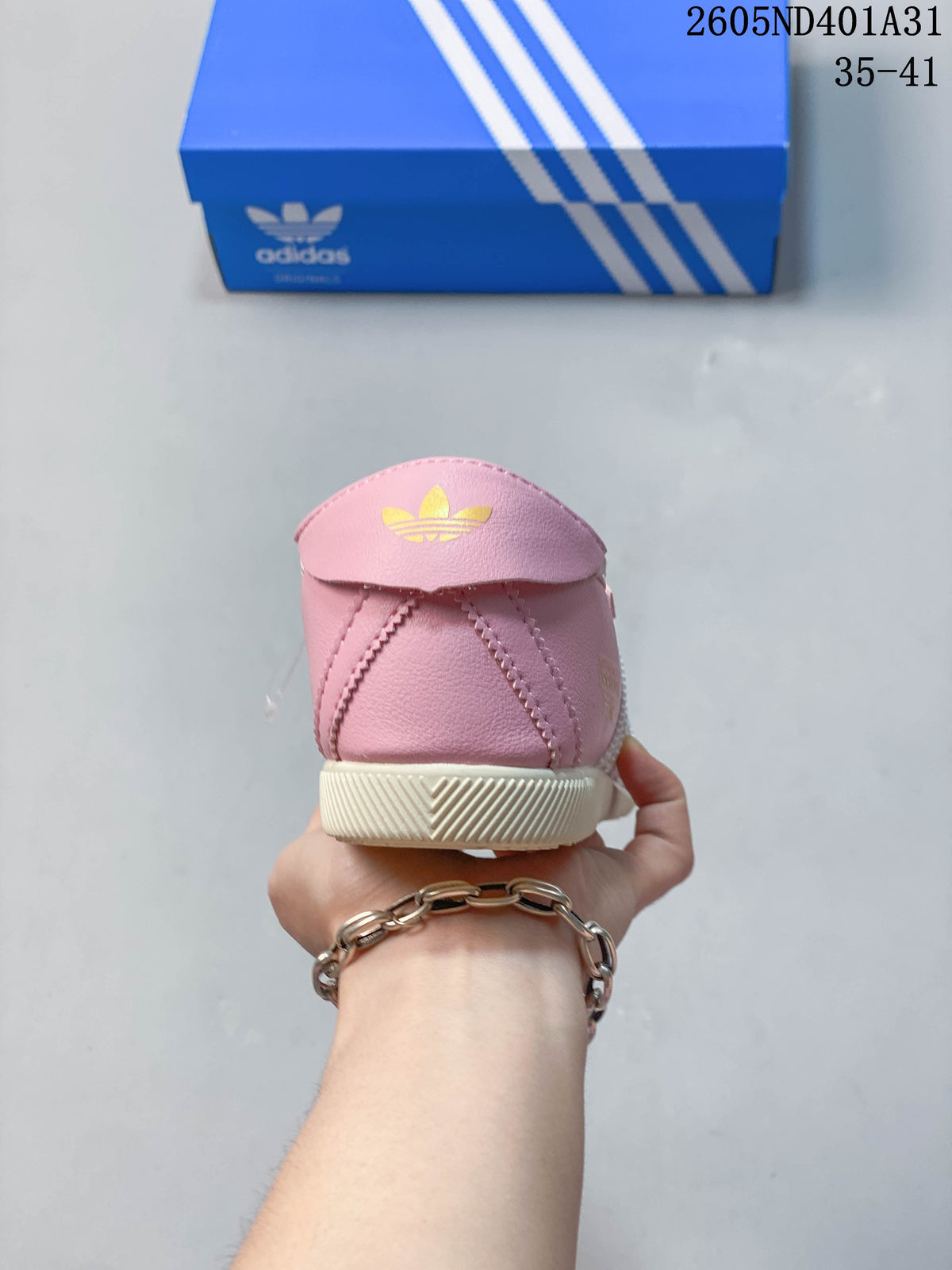 Rear view of the pink sneaker with a gold trefoil mark