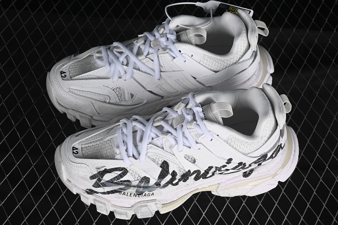 Pair of white Track sneakers with black side graphics