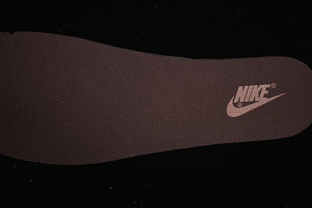 Close-up of the dark insole with a Nike logo.