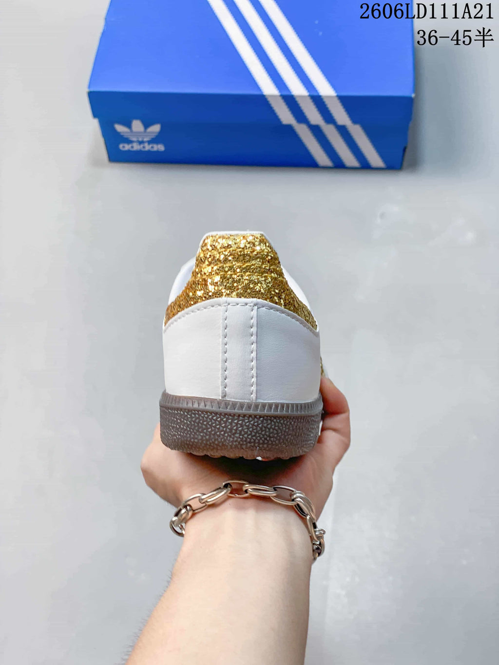 Rear view highlighting the gold-glitter heel detail and gum-colored outsole.