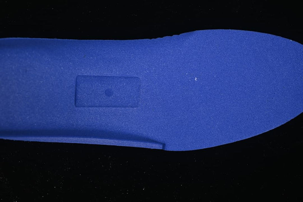 Blue shoe insert shown separately against a dark background