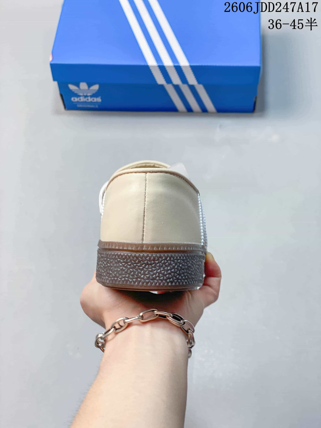 Rear view of a cream adidas Handball Spezial shoe showing the textured sole