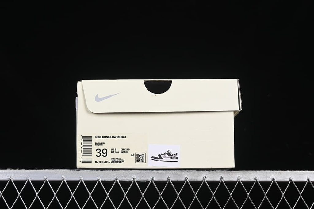 Sneaker box label identifying Nike Dunk Low Retro, color Black/Silver, style DJ2024-084, and size 39.