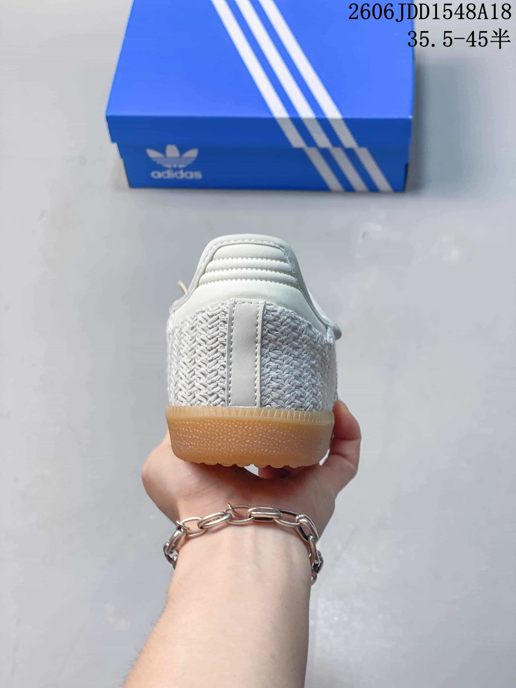 Rear view showing the woven-look heel and gum-colored outsole.