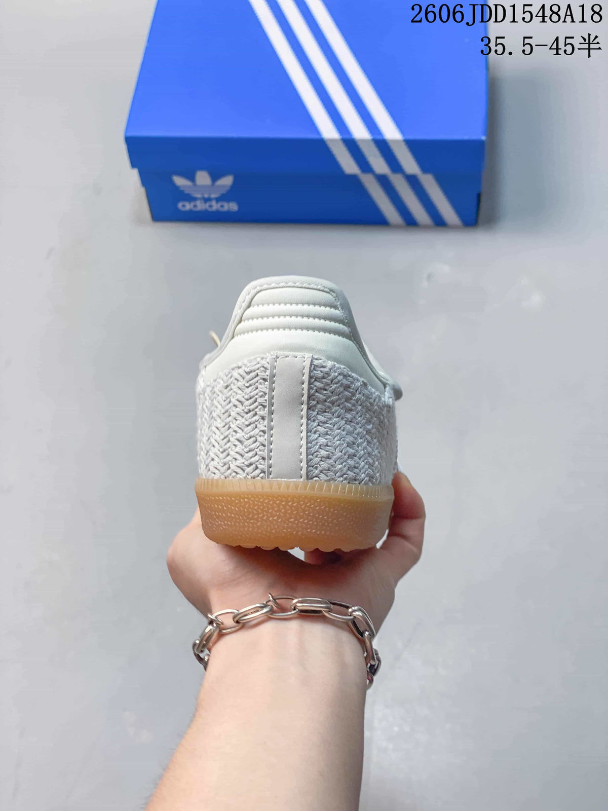Rear view showing the woven-look heel and gum-colored outsole.