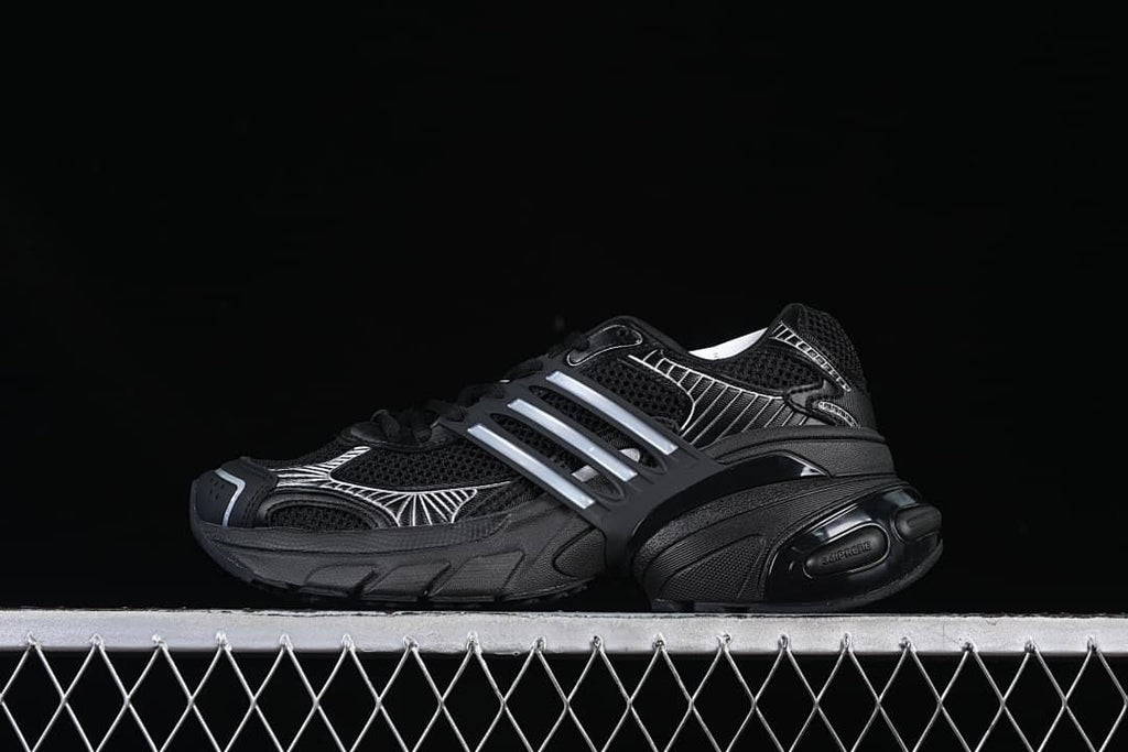 Side view of a black adidas Adistar XLG sneaker with silver accents
