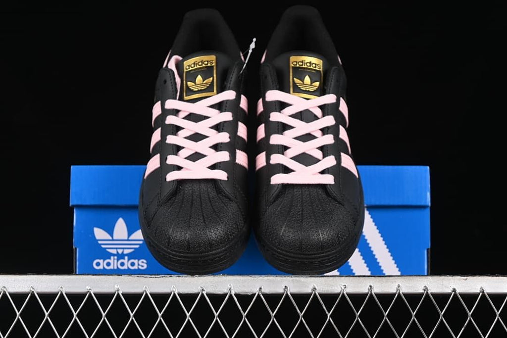 Front view of the pair showing textured shell toes and pink laces
