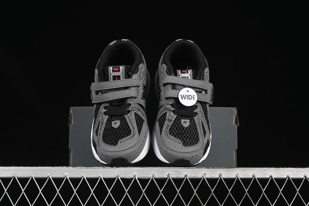 Front view of the pair with gray straps, black uppers, and white midsoles.