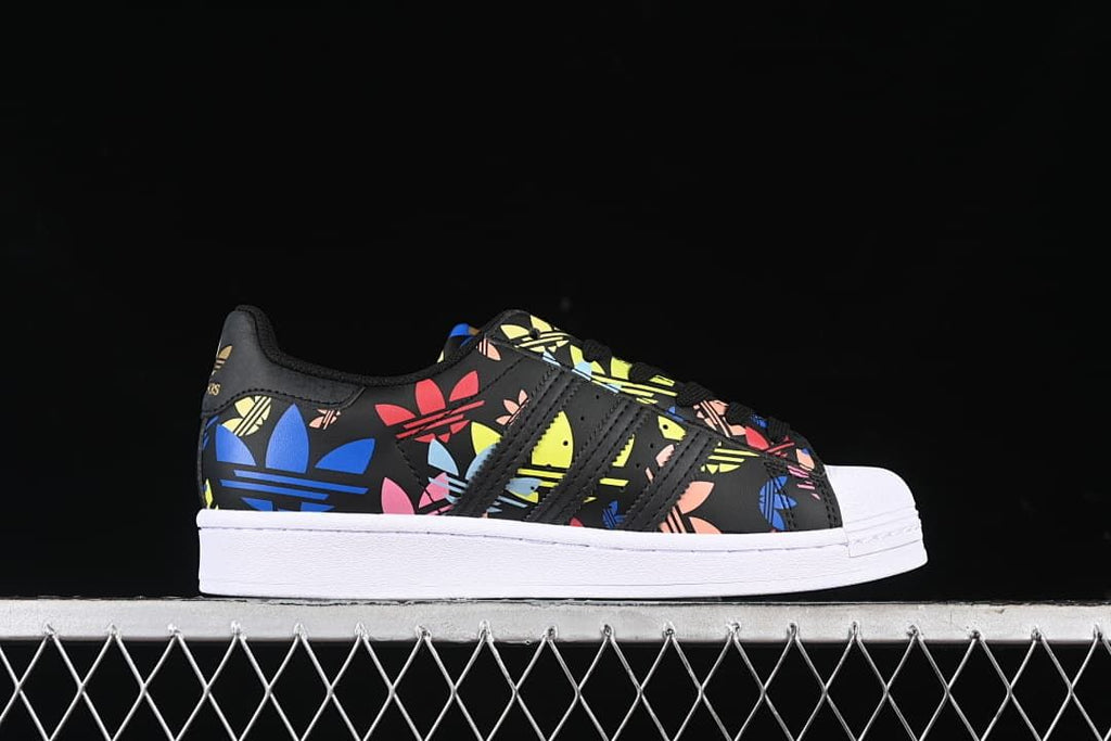 Side profile of the black graphic sneaker with white sole