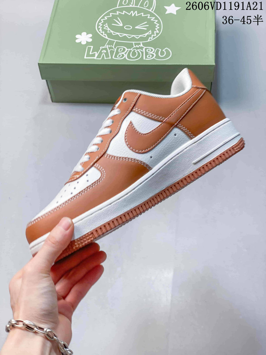 Side profile of brown-and-white low-top sneaker with LABUBU graphics