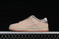 Side profile of a beige and grey Nike SB Dunk Low with brown laces and a gum-colored outsole