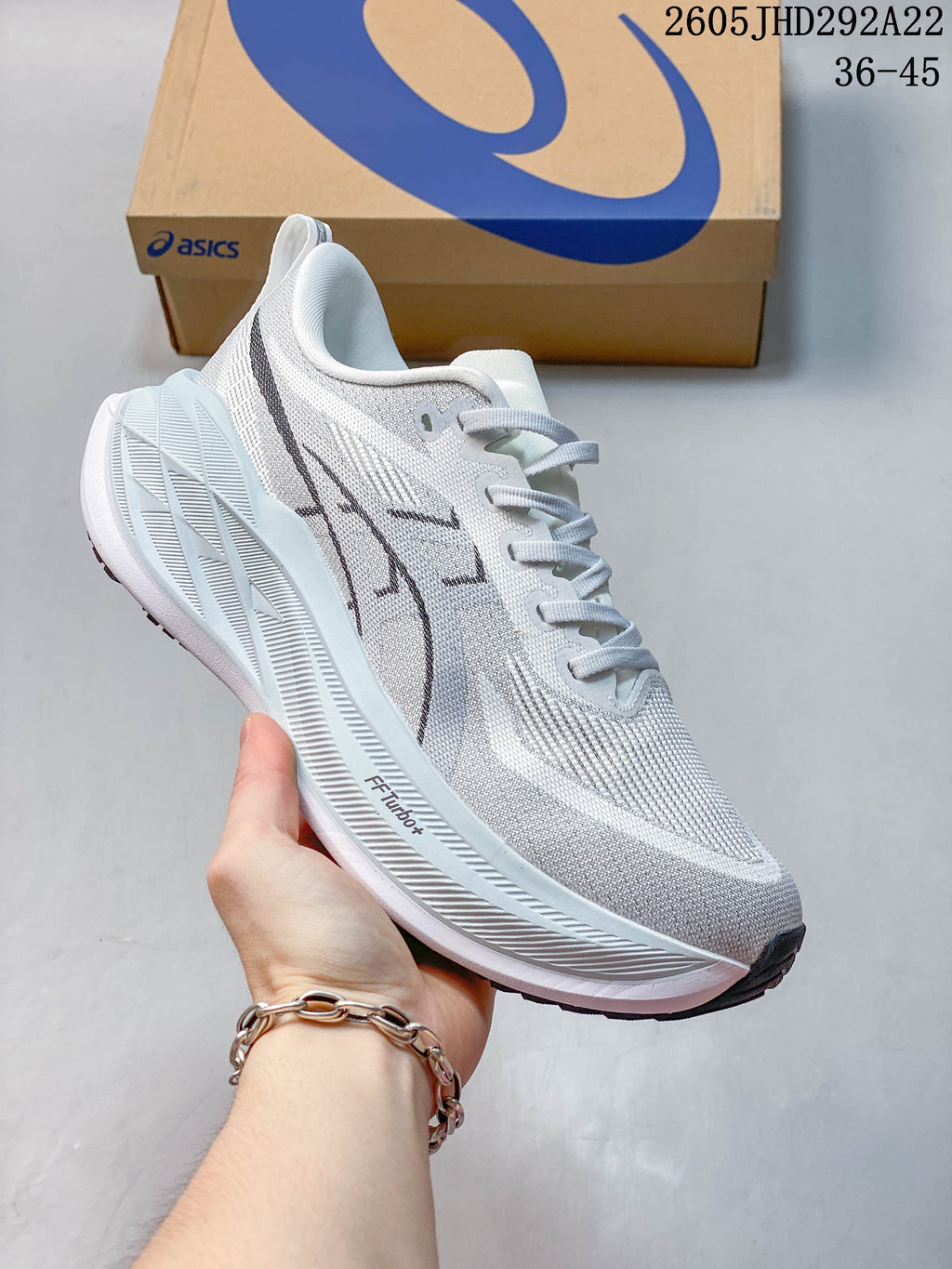 White and gray ASICS Superblast 2 Paris running shoe with pale blue midsole details.