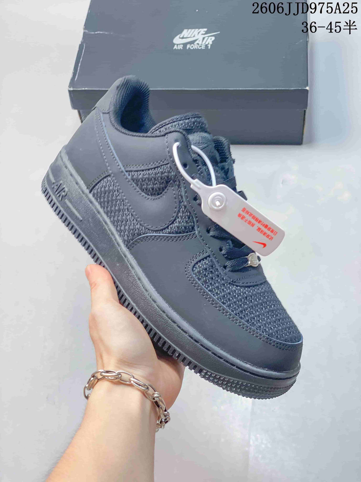 Side view of a dark gray low-top sneaker with woven-look panels