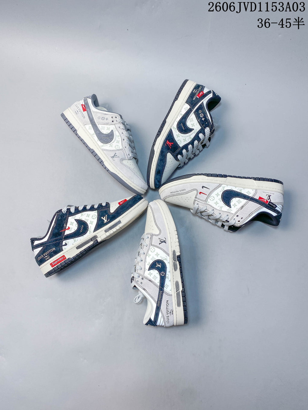 Several light gray and navy low-top sneakers arranged in a circle